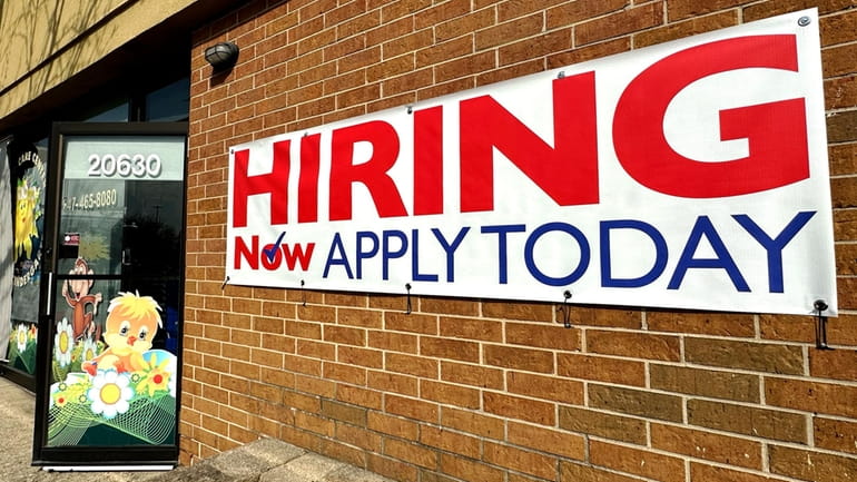 A hiring sign is displayed in Riverwoods, Ill., Tuesday, April...