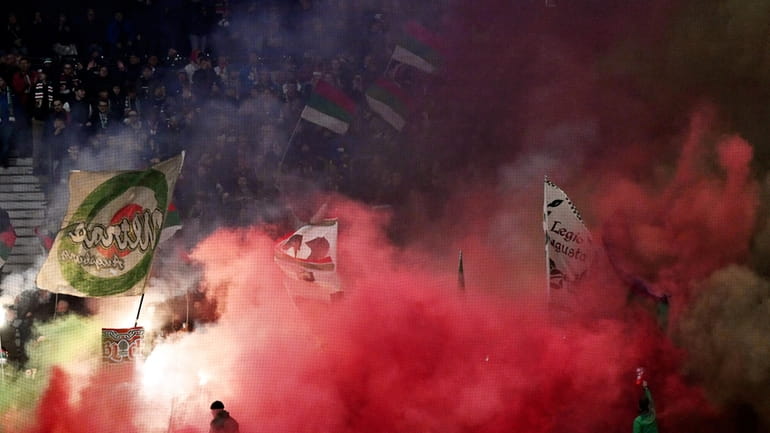 Augsburg fans set off pyrotechnics during the German Bundesliga soccer...