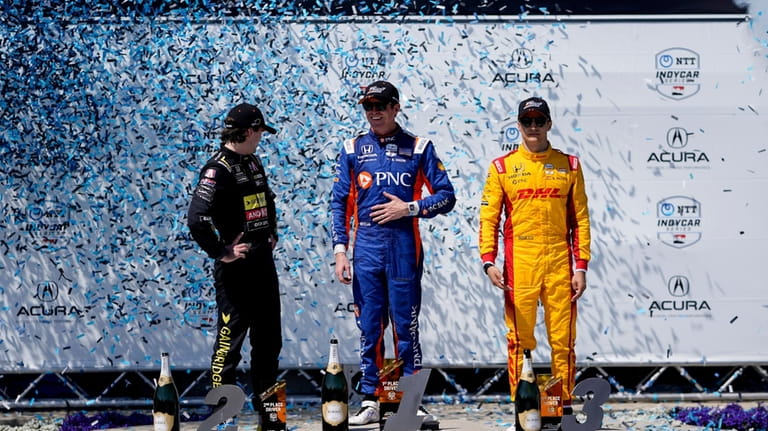 Chip Ganassi Racing driver Scott Dixon, center, celebrates his first...