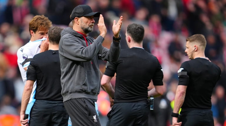 Liverpool's manager Jurgen Klopp applaud supporters at the end of...