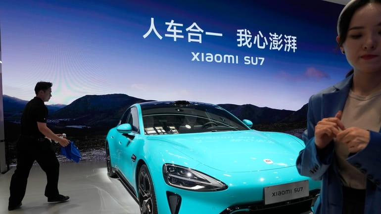 The Xiaomi SU7 is displayed with the slogan, "The car...