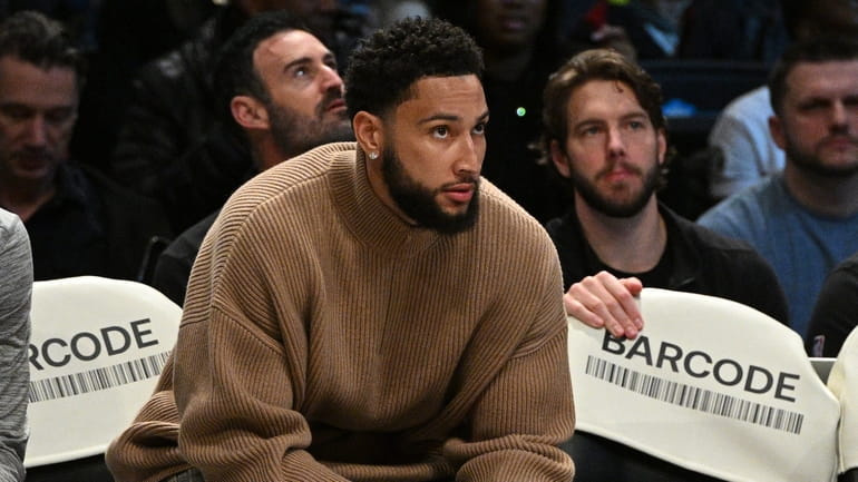 Brooklyn Nets guard Ben Simmons looks on from the bench...