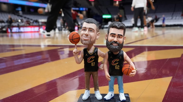 A bobblehead of Cleveland natives Travis and Jason Kelce stands...