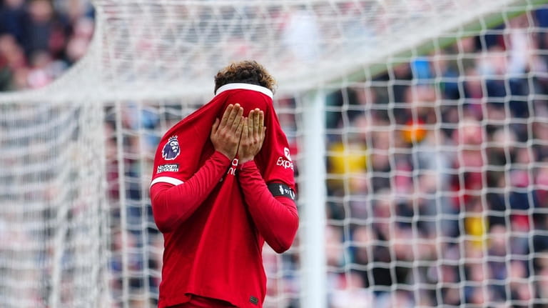 Liverpool's Curtis Jones reacts after missing a scoring chance during...
