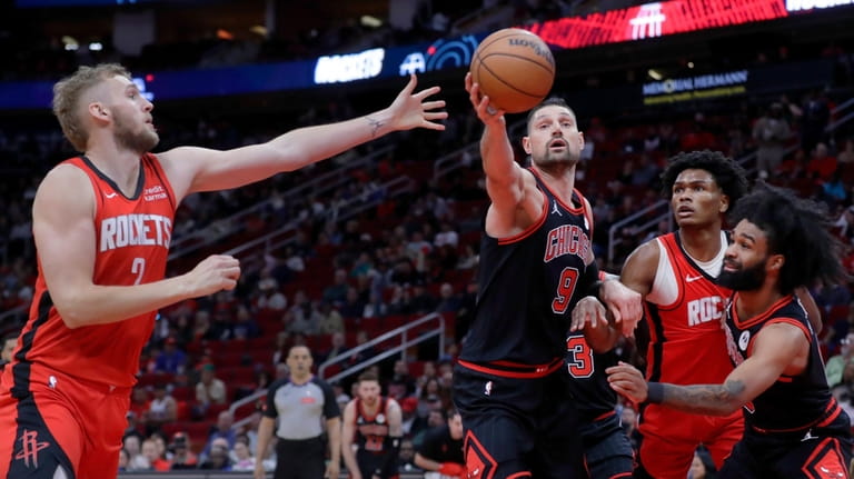 Chicago Bulls center Nikola Vucevic (9) gets a rebound before...