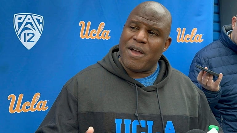 UCLA associate head coach and offensive coordinator Eric Bieniemy speaks...