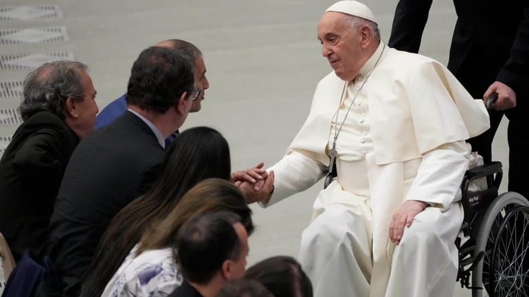 Pope Francis greets Bassan Aramin, left, and Rami Elhanan during...