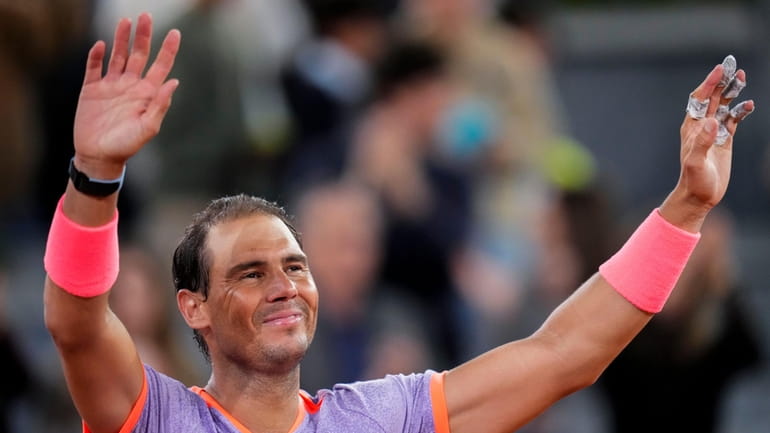 Rafael Nadal, of Spain, celebrates after winning to Alex de...