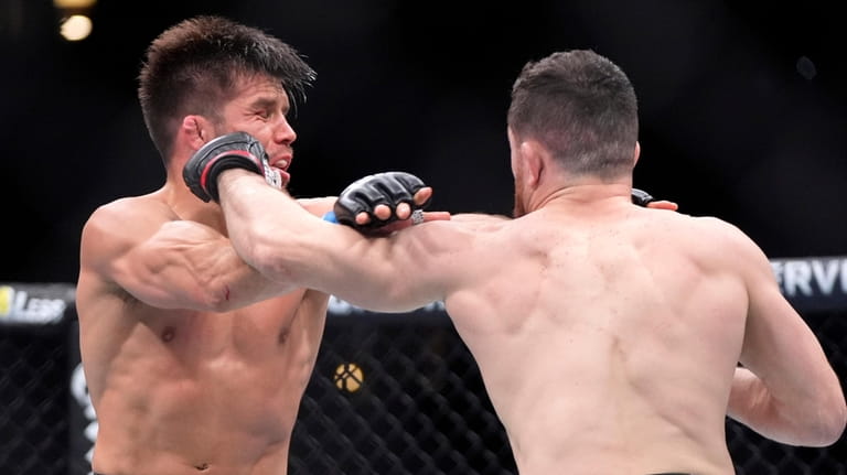 Merab Dvalishvili, right, connects with Henry Cejudo during their bantamweight...