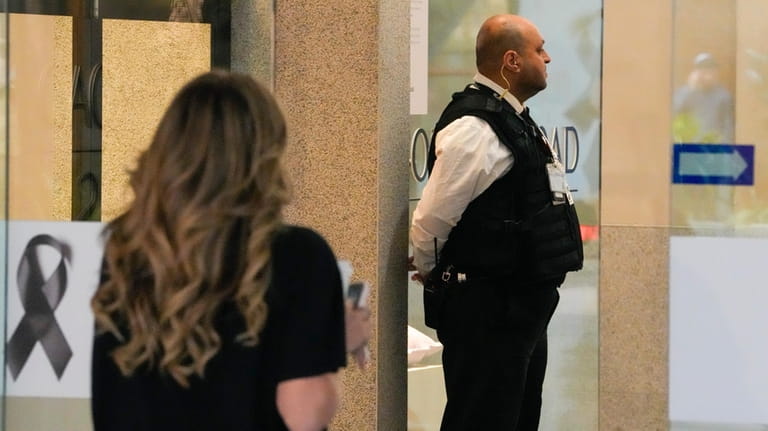 A security guard watches as shoppers return to the Westfield...