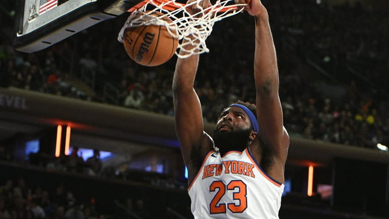 Knicks center Mitchell Robinson dunks against the Celtics during the...