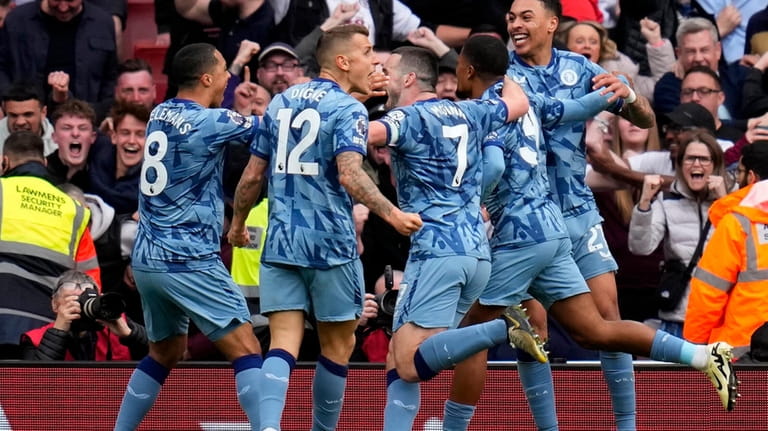 Aston Villa's Leon Bailey (31) celebrates with team mates after...