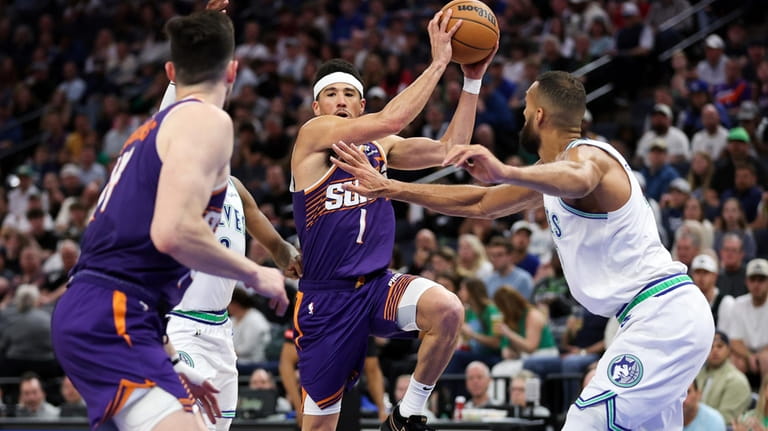 Phoenix Suns guard Devin Booker (1) works toward the basket...