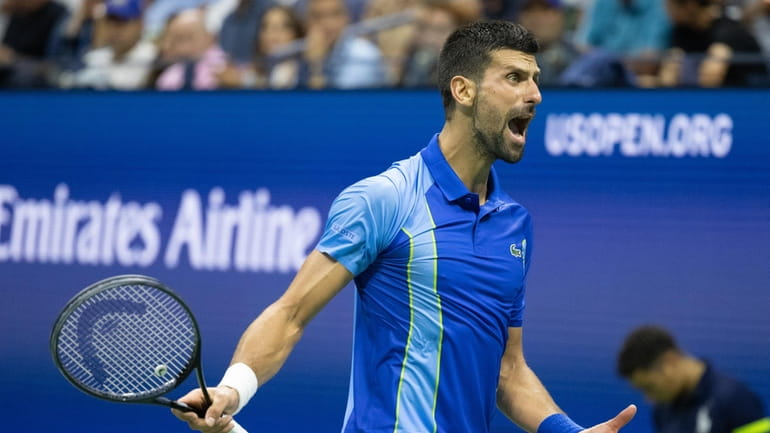 Novak Djokovic yells while struggling in the second set against...