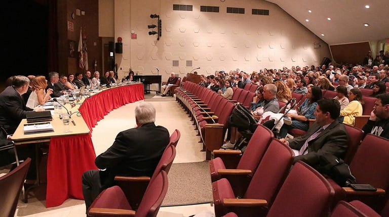 Syosset residents fill the auditorium at South Woods Middle School on...