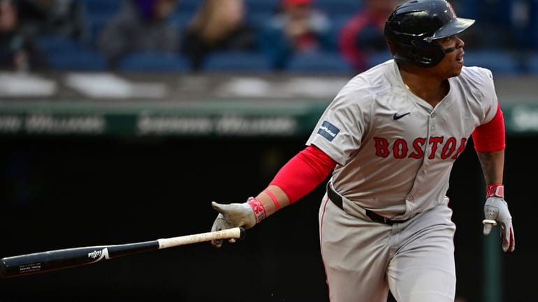 Boston Red Sox's Rafael Devers watches his solo home run...