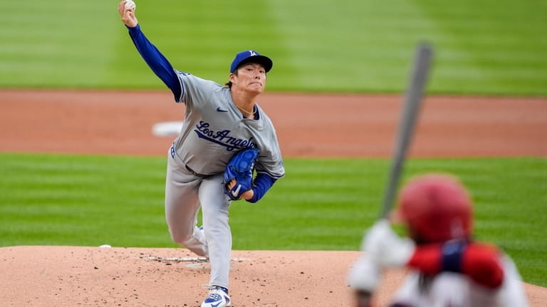 Los Angeles Dodgers starting pitcher Yoshinobu Yamamoto throws during the...