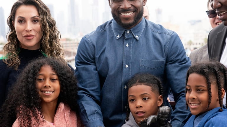 Former USC football player Reggie Bush poses with his family...