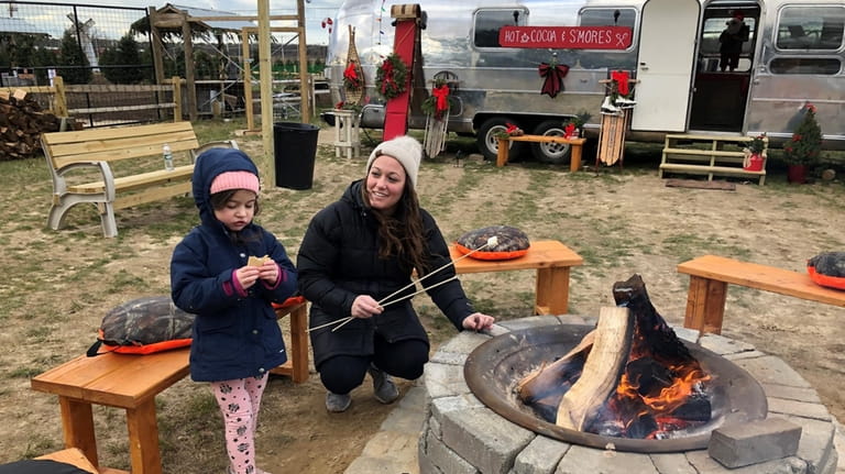 Jen Giordano and her daughter, Juliana, make s’mores at the...
