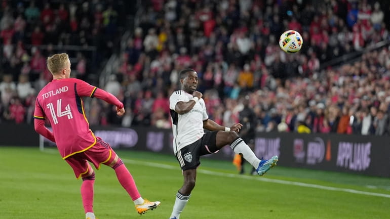 D.C. United's Cristian Dajome, right, clears the ball as St....
