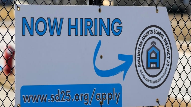 A hiring sign is displayed in Arlington Heights, Ill., Monday,...