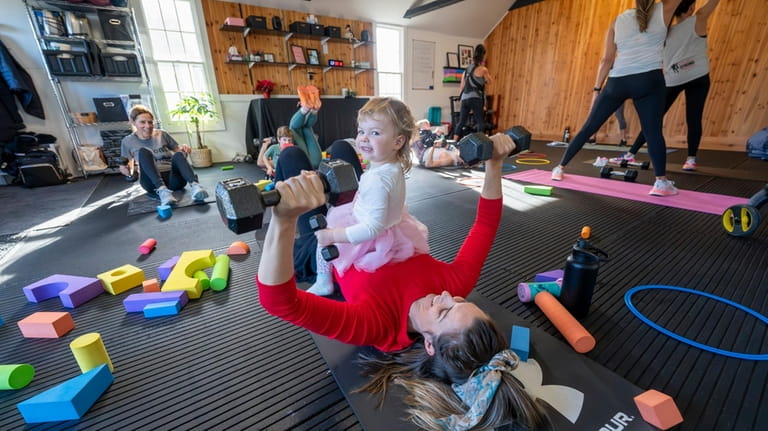 Jackie Grossklaus of Riverhead and her daughter Leyana, 2, workout...