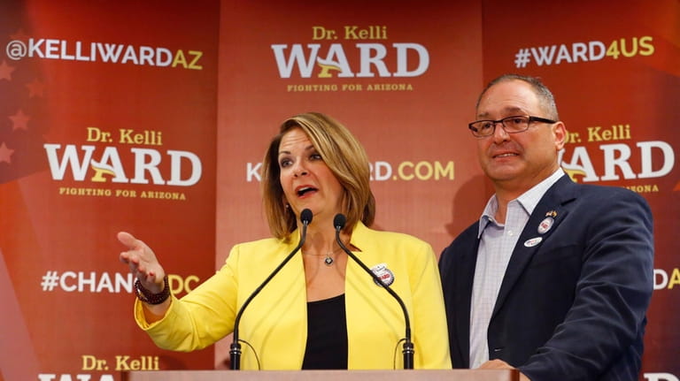 Kelli Ward, with her husband Michael Ward at her side,...