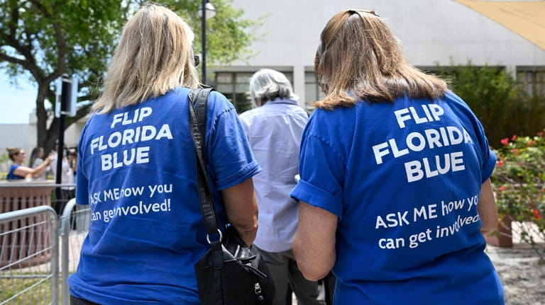 Supporters wear shirts with the message "Flip Florida Blue" while...