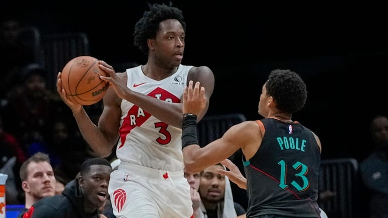 Toronto Raptors forward O.G. Anunoby, left, looks to pass as...