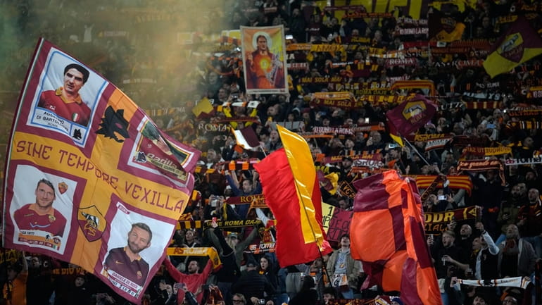 Fans of Roma cheer for their team prior to the...