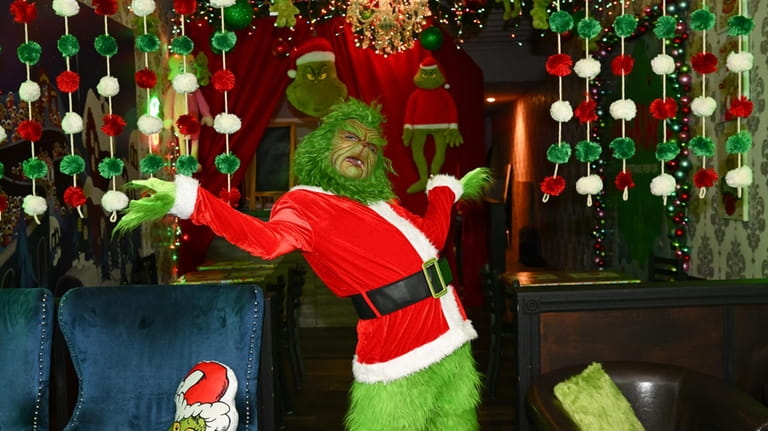 Charles Jacker strikes a pose as Mr. Grinch at the holiday...