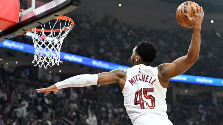 Cleveland Cavaliers' Donovan Mitchell dunks during the first half against...