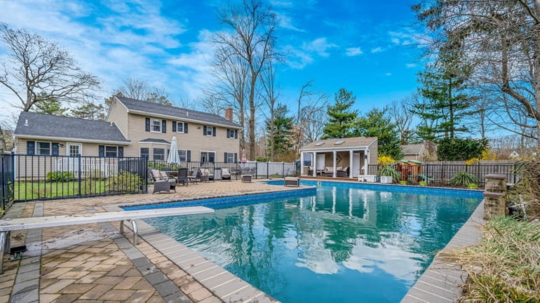 This Hauppauge home with a large, L-shaped pool is listed...