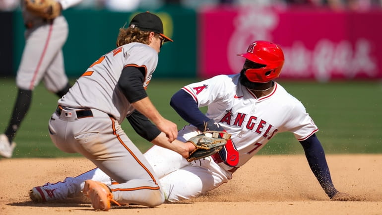 Los Angeles Angels' Jo Adell (7) is caught stealing second...