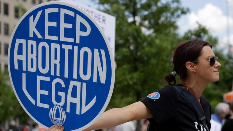 An abortion-rights demonstrator holds a sign during a rally, May...