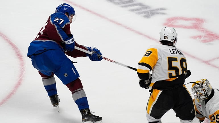 Colorado Avalanche left wing Jonathan Drouin, left, scores the winning...