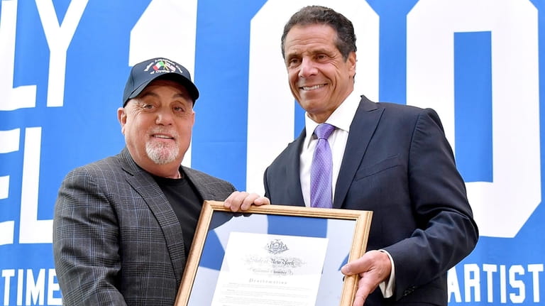 Billy Joel and then-Gov. Andrew Cuomo pose with a framed commemoration...
