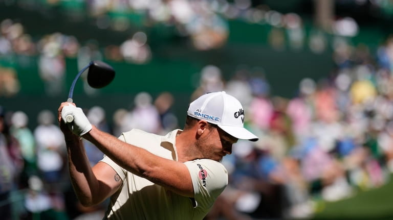 Danny Willett, of England, hits his tee shot on the...