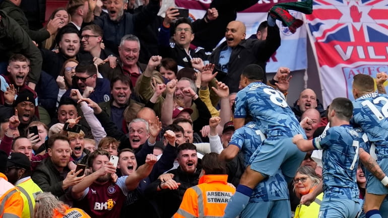 Aston Villa's Ollie Watkins celebrates with team mates after scoring...
