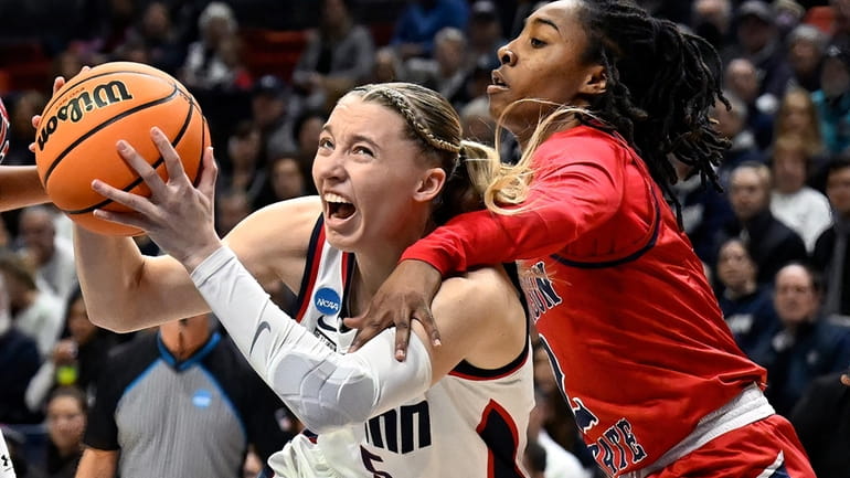 UConn guard Paige Bueckers, left, is fouled by Jackson State...
