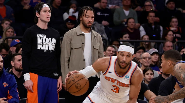 Jalen Brunson of the Knicks looks on from the bench during...