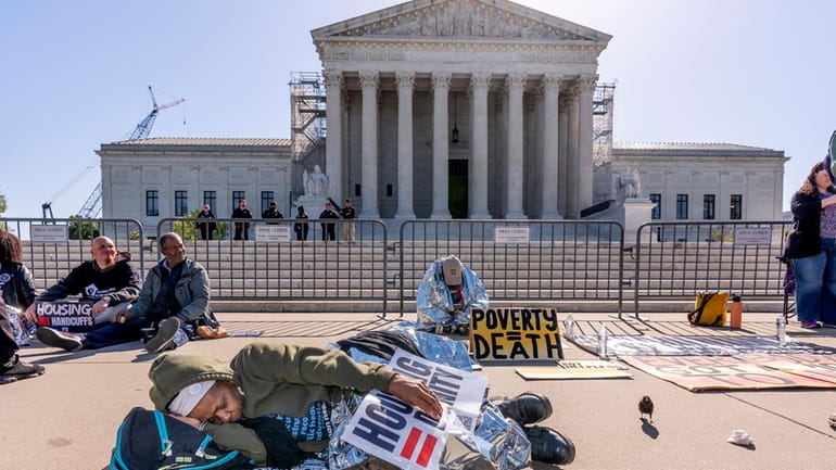 Activists demonstrate at the Supreme Court as the justices consider...