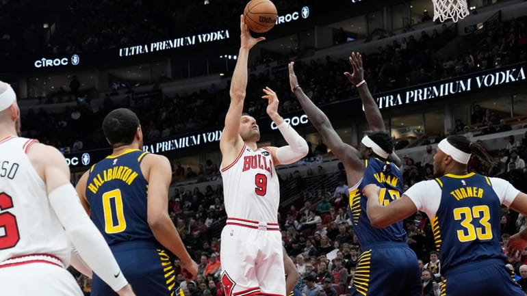Chicago Bulls center Nikola Vucevic (9) shoots over Indiana Pacers...