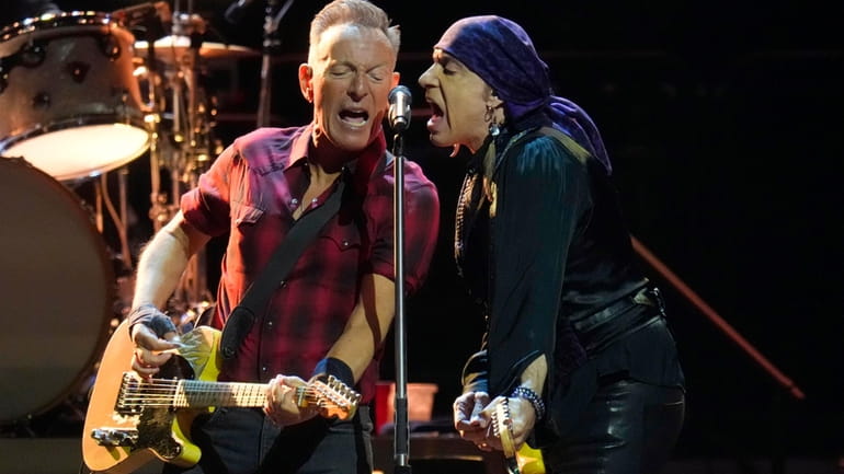Bruce Springsteen, left, and Stevie Van Zandt, right, sing during...