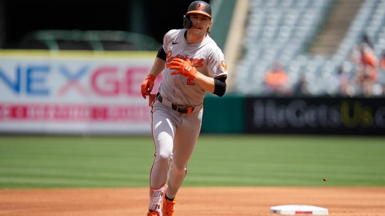 Baltimore Orioles' Gunnar Henderson runs the bases after hitting a...