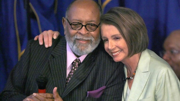 House Speaker Nancy Pelosi, right, hugs Reverend Cecil Williams before...