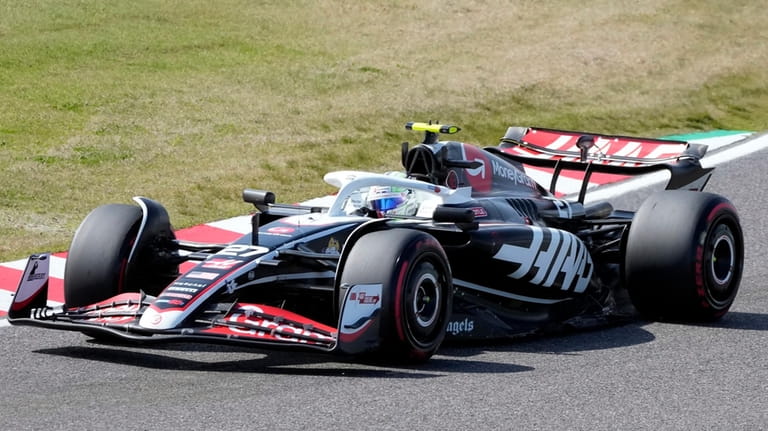 Haas driver Nico Hulkenberg of Germany steers his car during...