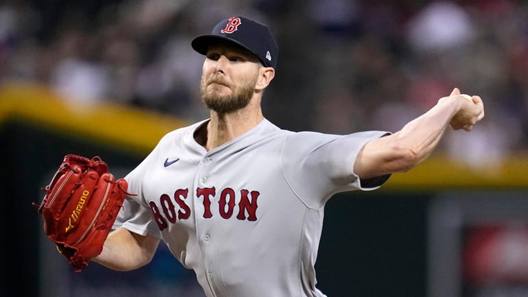 Boston Red Sox starting pitcher Chris Sale throws to an...