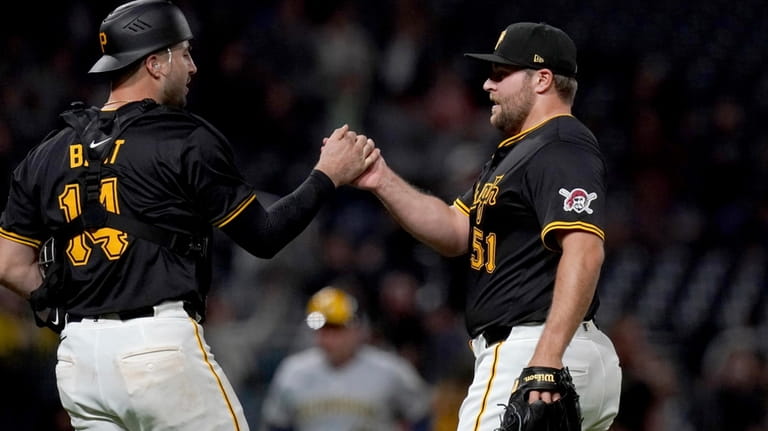 Pittsburgh Pirates relief pitcher David Bednar, right, celebrates with catcher...