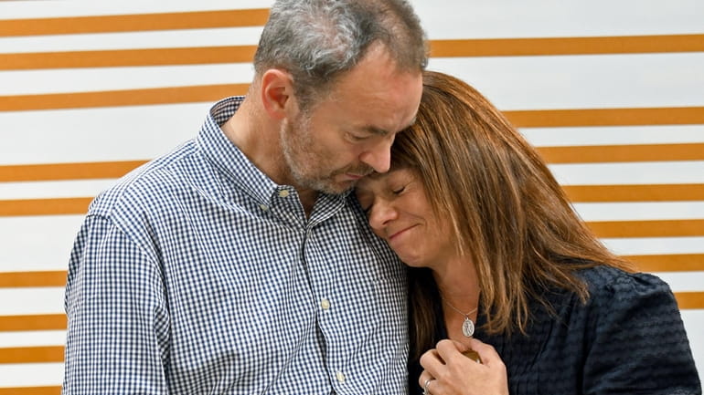 Simon and Sally Glass comfort each other during an emotional...
